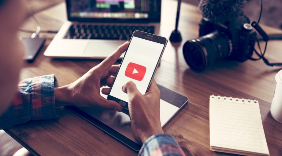 Creative or producer planning about his upload video to youtube and Editing vlog of his on laptop and camera for youtube | RM Warner Inernet Law Firm