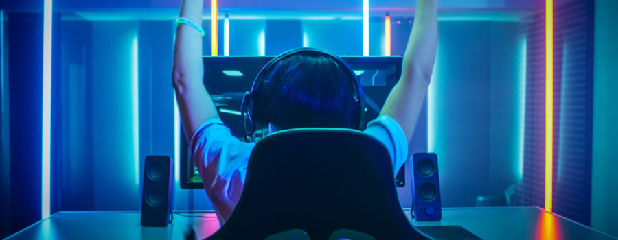 esports player with hands up after winning game | RM Warner Inernet Law Firm
