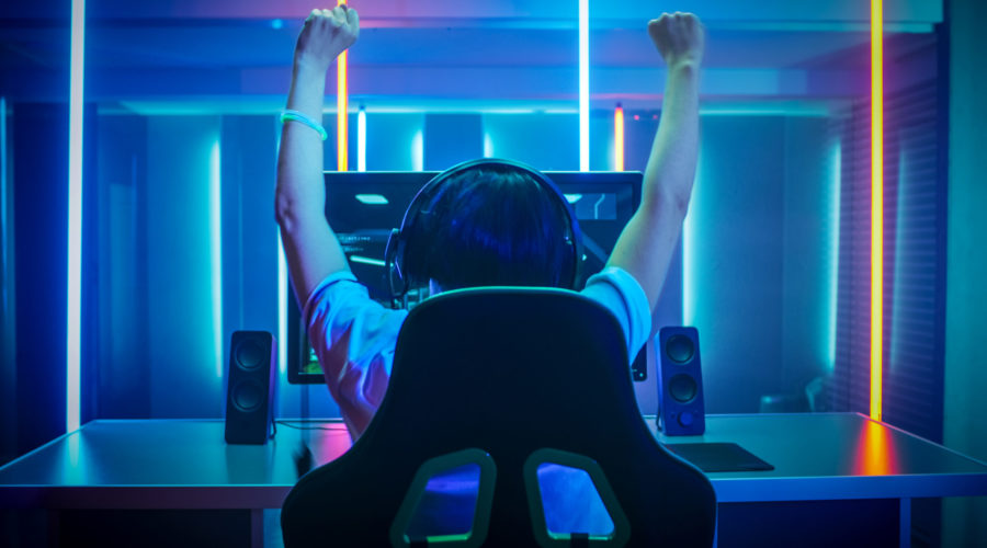 esports player with hands up after winning game | RM Warner Inernet Law Firm