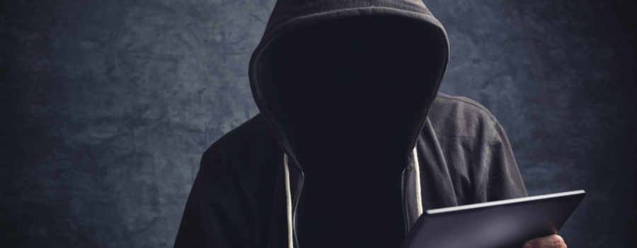 Amazon Black Hat Market | anonymous man in black hoodie holding ipad | RM Warner Inernet Law Firm