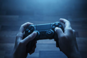 hands holding video game controller | RM Warner Inernet Law Firm