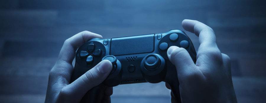 hands holding video game controller | RM Warner Inernet Law Firm
