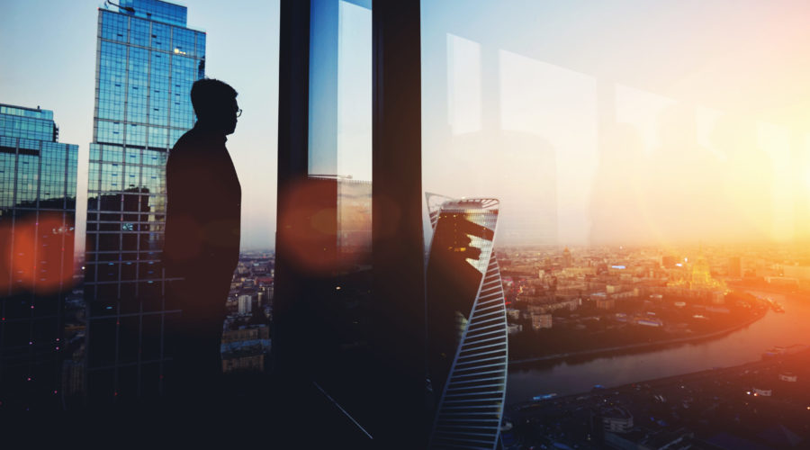 man looking out large window of office building | RM Warner Inernet Law Firm