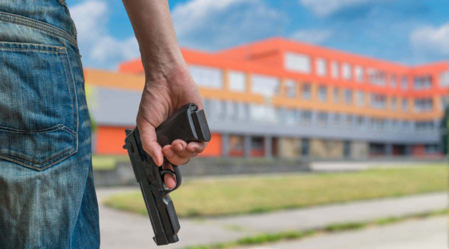 school shooter standing in front of school | violent acts | RM Warner Internet Law Firm