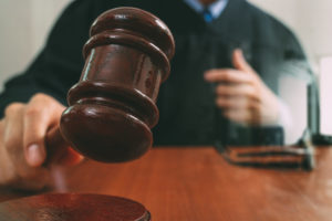 judge hitting wooden gavel | RM Warner Internet Law Firm | Jussie Smollett | Daniel R. Warner | Daniel Warner | Raees Mohamed