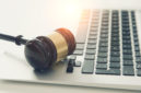 Wooden gavel on laptop keyboard | RM Warner Inernet Law Firm