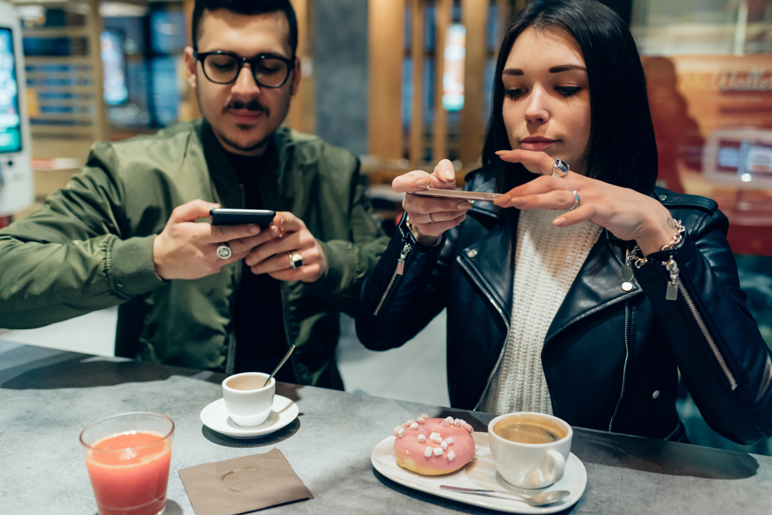 Young couple photographing food with smart phone - social network, sharing, food blogger concept | RM Warner Inernet Law Firm