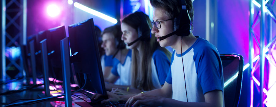 line of kids playing esports on monitors at tournament | RM Warner Inernet Law Firm