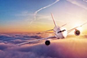 plane flying above the clouds | RM Warner Inernet Law Firm