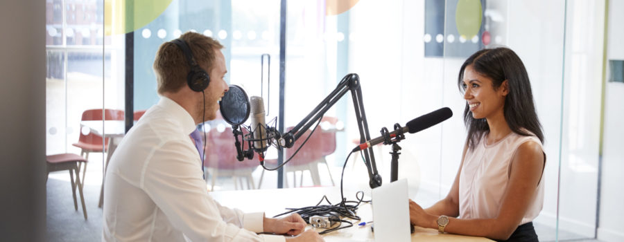 two radio show hosts speaking across from each other in studio | RM Warner Internet Law Firm | Dean Obeidallah | Daniel Warner | Daniel R. Warner | Raees Mohamed