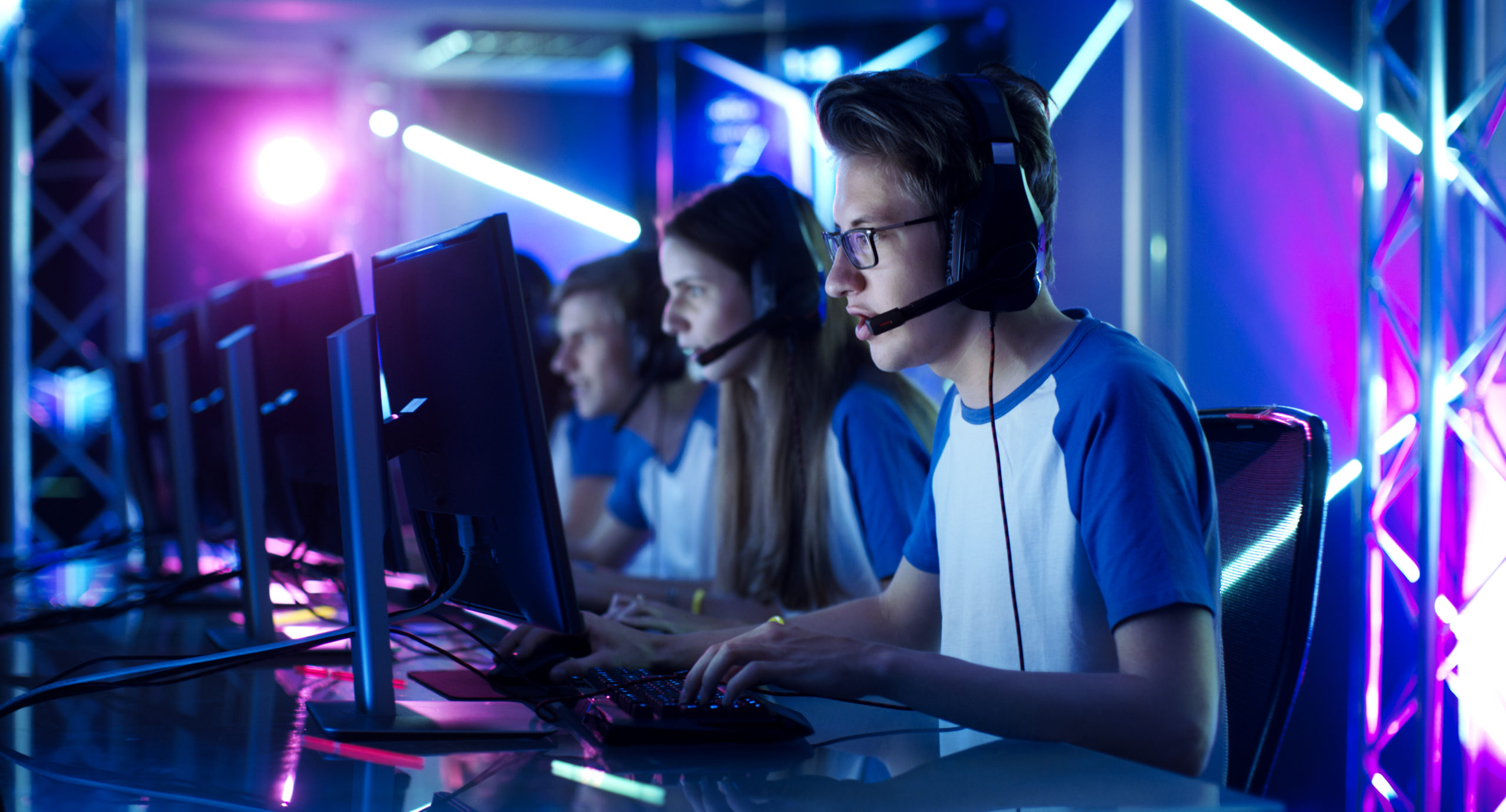 line of kids playing esports on monitors at tournament | RM Warner Internet Law Firm