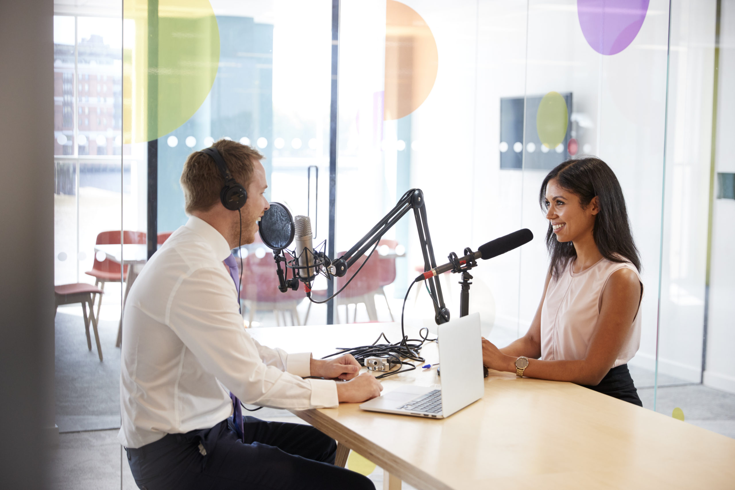 two radio show hosts speaking across from each other in studio | RM Warner Internet Law Firm | Dean Obeidallah | Daniel Warner | Daniel R. Warner | Raees Mohamed